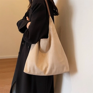 Minimalist beige suede hobo tote bag with slim brown strap for modern women's daily commute