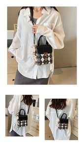 Detail showing elegant argyle pattern mini bag with a cute white plush bunny charm