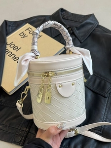 Chic quilted cylindrical bucket bag in cream faux leather with printed silk scarf handle