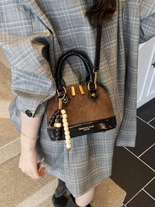 Quilted faux suede shell crossbody bag with beaded charm and black leather trim