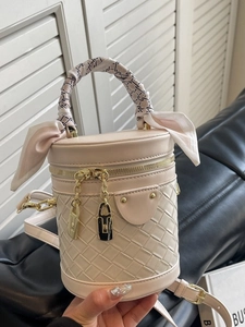 Chic quilted cream cylinder bucket bag with woven leather pattern and silk scarf handle