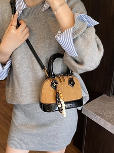 Quilted brown suede shell crossbody bag with wooden bead charm and black handles