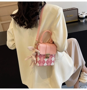Pink quilted crossbody bag with a gold lock and a cute plush rabbit pendant detail