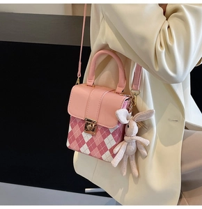 Pink quilted mini bag details with cute knit bunny charm and elegant metal clasp