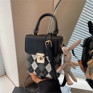 Quilted mini crossbody bag with black white pattern and cute rabbit charm detail