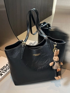 Glossy black PU leather tote bag with gold lettering and a checkered rabbit charm