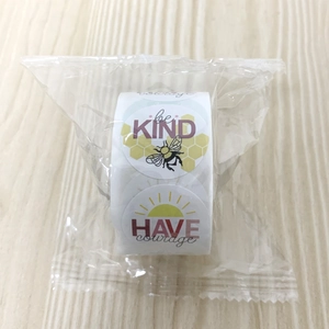 Detail of inspirational round sticker roll featuring be KIND and HAVE courage designs