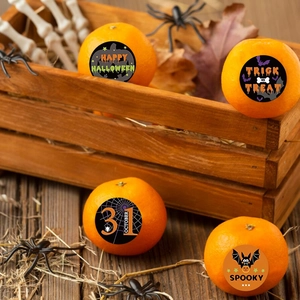 Macro shot of Halloween stickers on pumpkins featuring bats and spooky festive text