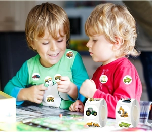 Close-up of colorful construction vehicle stickers on a roll for kids' crafts