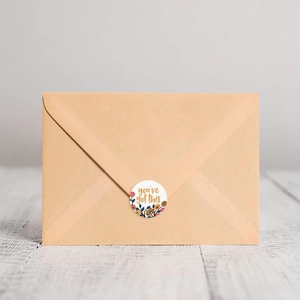 Floral round sticker with 'you've got this' text used on a kraft paper envelope