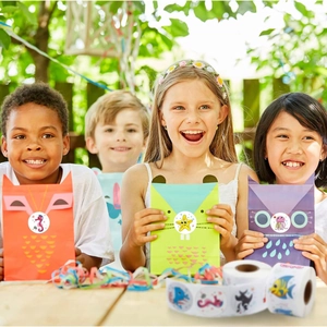 Children at a garden party using cartoon animal paper bags and ocean stickers