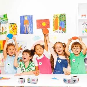 Kids interacting with colorful round ocean animal reward stickers in a classroom setting