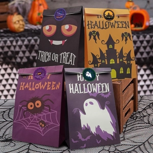 Close-up of four colorful Halloween gift bags with stickers on a festive background