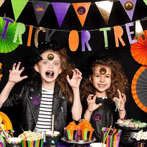 Kids using Halloween stickers with pumpkin and castle designs for party decoration