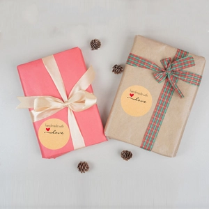 Round kraft paper stickers with handmade with love text on gift boxes with pine cones