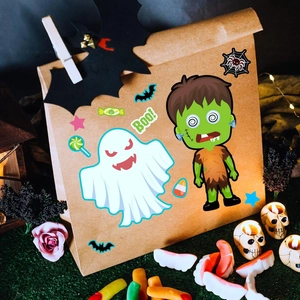 Halloween gift bag decorated with cartoon monster stickers and spooky festive props