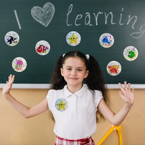 Detail of holographic ocean creature reward stickers on a classroom blackboard setting