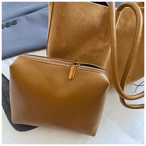 Close-up of brown suede tote bag and matching leather zipper pouch for office commute