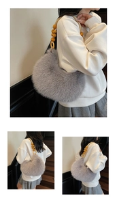 Detail of grey faux fur crescent bag with decorative yellow wooden bead handle
