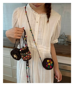 Detail of bohemian mini bags with colorful beads and handmade woven brown straps