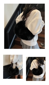 Detail of plush crescent bag with wooden bead handle and soft black faux fur texture