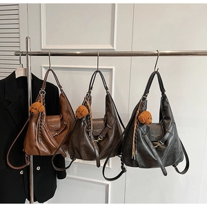 Three retro faux leather crossbody bags in brown, coffee and black with plush puppy charms