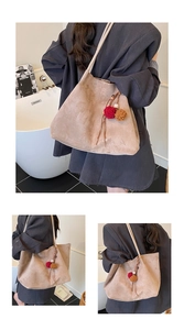 Detail of khaki suede tote bag with fringe charm and spacious interior for casual style