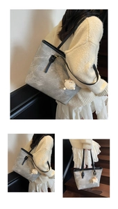 Detailed close-up of large tote bag with marbled gray texture and plush charm