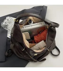 Top view of spacious brown tote bag interior with umbrella, book and daily essentials