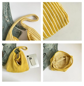 Detail of yellow and white striped knit tote bag with wooden bead charm and soft texture