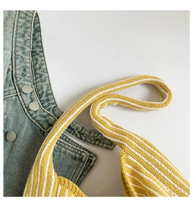 Close-up of yellow and white striped knitted tote bag with textured knit detail