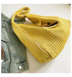 Detail of yellow and white striped knit tote bag showing soft ribbed cotton texture