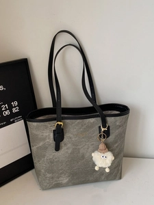 Gray-green marble pattern leather tote bag with black handles and cute plush charm pendant