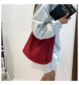 Detail of red and black striped knit tote bag with premium vertical textured stitching
