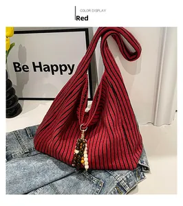 Detail of red and black striped knit tote bag with colorful beaded tassel ornaments