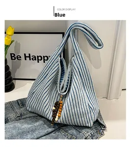 Blue and beige vertical stripe knit tote bag with decorative wooden bead tassels detail