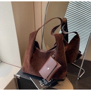 Detail of a dark brown suede tote bag with a matching leather mini pouch and metal hook