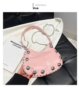Detail of pink hobo bag featuring large silver studs and metallic chain strap