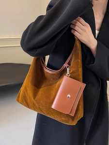 Vintage dark brown suede hobo bag with a small matching pouch shown on a model side view