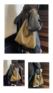 Detail of woven texture on a large olive green hobo bag showing high-quality craftsmanship