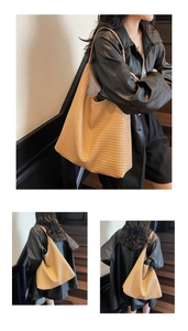 Detail of a large woven tote bag in khaki showing high-quality texture and crossbody style