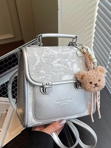 Silver grey leather backpack with marble pattern flap and a cute plush bear pendant