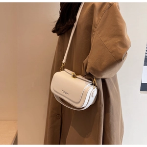 Close-up of white leather shoulder bag featuring gold clasp and FASHION & BAGS inscription