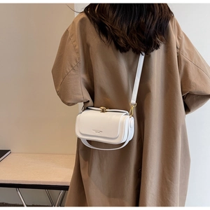 Detail of white square crossbody bag with gold buckle and fashion leather lettering