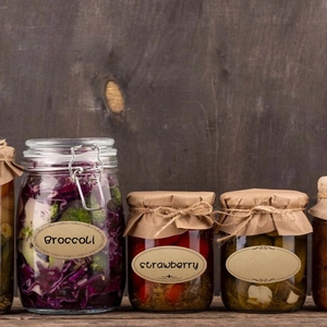 Oval kraft paper labels for food jars featuring vintage decorative borders and string