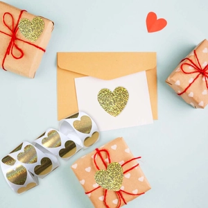 Roll of gold laser heart stickers for Valentine gift wrapping and envelope sealing