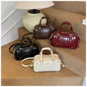 Macro view of four color stylish Boston bags on stairs with gold hardware detail