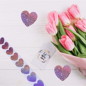 Close-up of pink glitter heart stickers on a roll for gift decoration and DIY projects