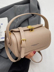 Beige leather cylinder handbag with a gold shell buckle and a detachable shoulder strap