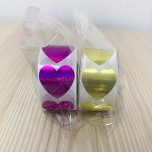 Detail of heart-shaped laser purple and golden metallic adhesive sticker rolls